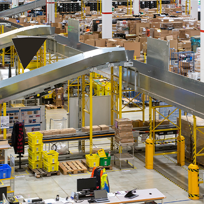 Conveying, chute material handling system from a fulfillment center